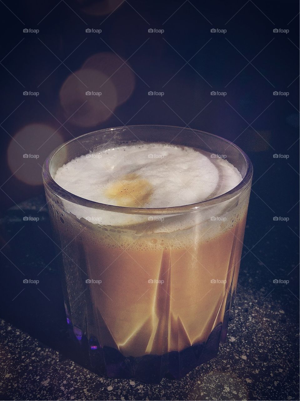 Glass of coffee in ray of sunshine