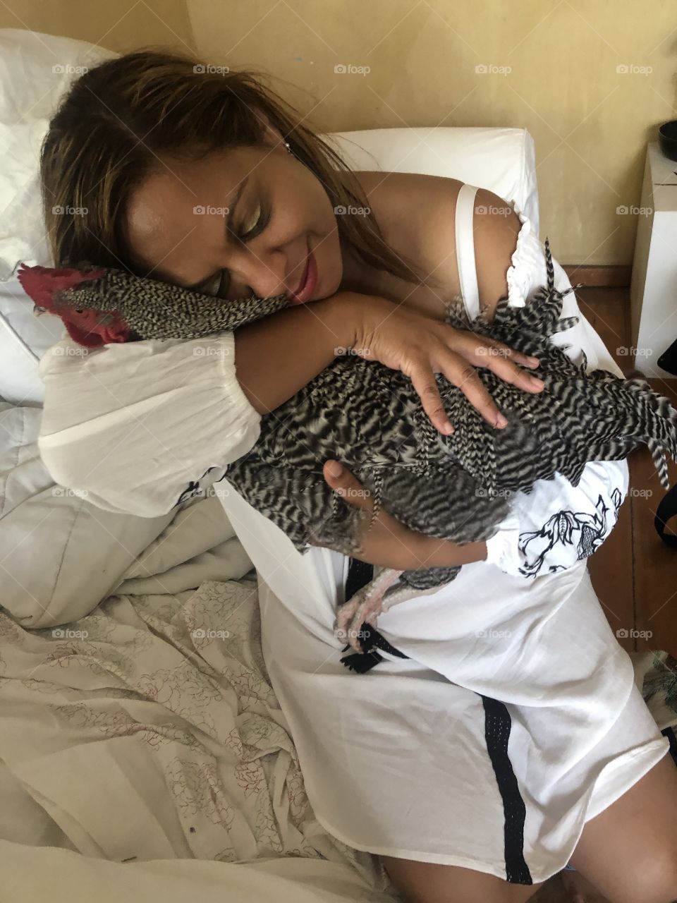 Woman cuddling rooster