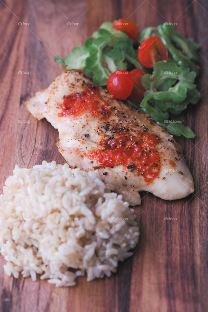 Healthy eating.  Brown rice, chicken and bitter melon with cherry tomato