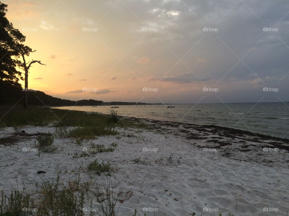 Calm beach in Saint Teresa Florida at sunset. 