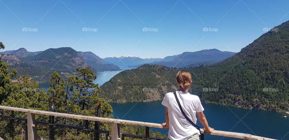 A woman enjoying the view over a lake and mountains in San Martin de los Andes, Argentina