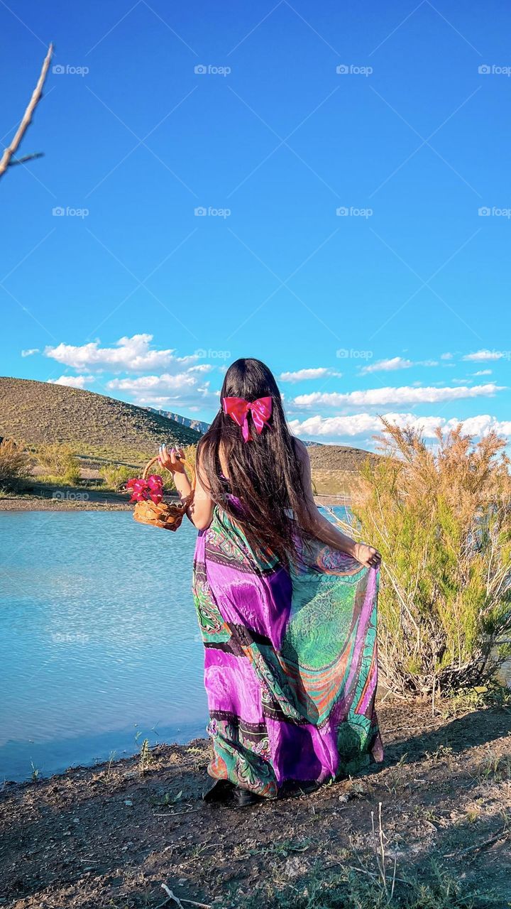 The girl with long hair by the lake