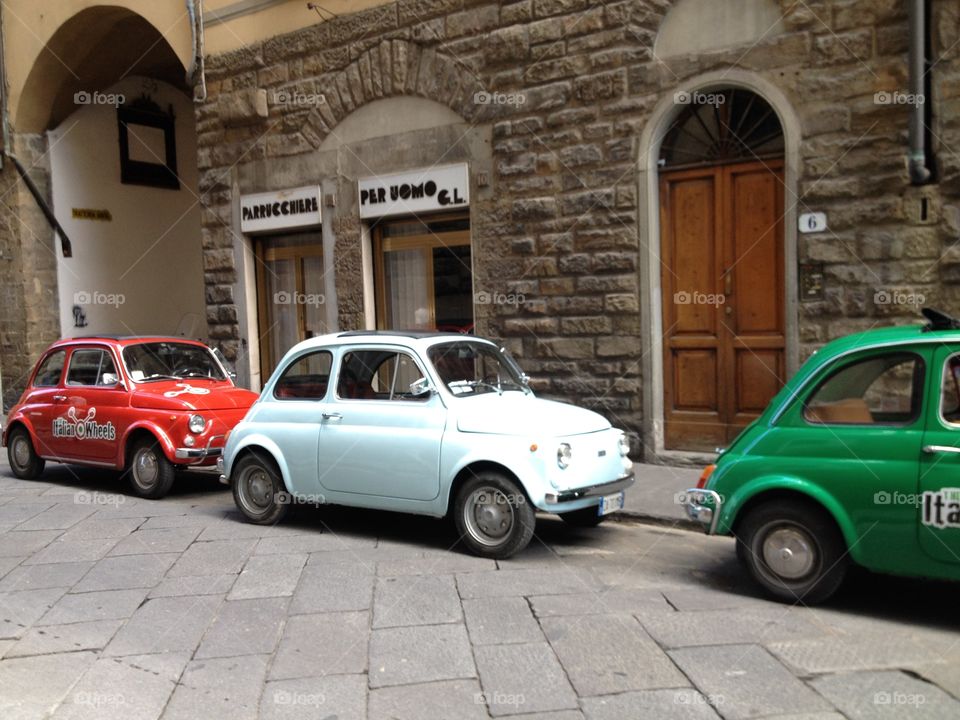 Bright Italian Cars . Bright Italian cars on cobblestone street