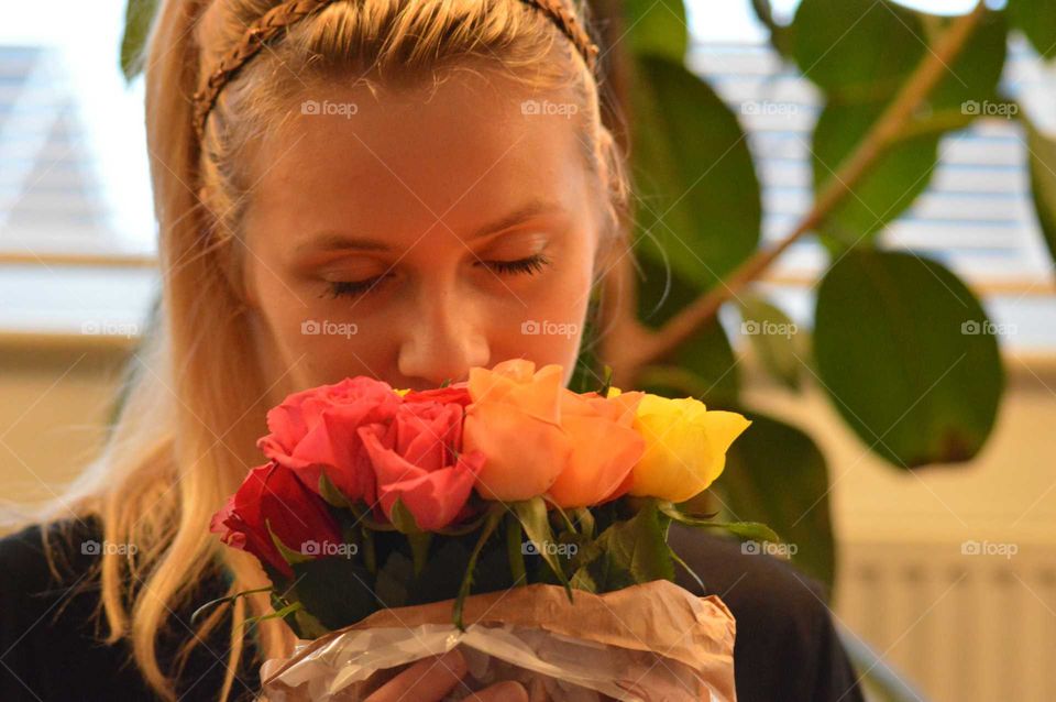 Woman smelling rose bouquet