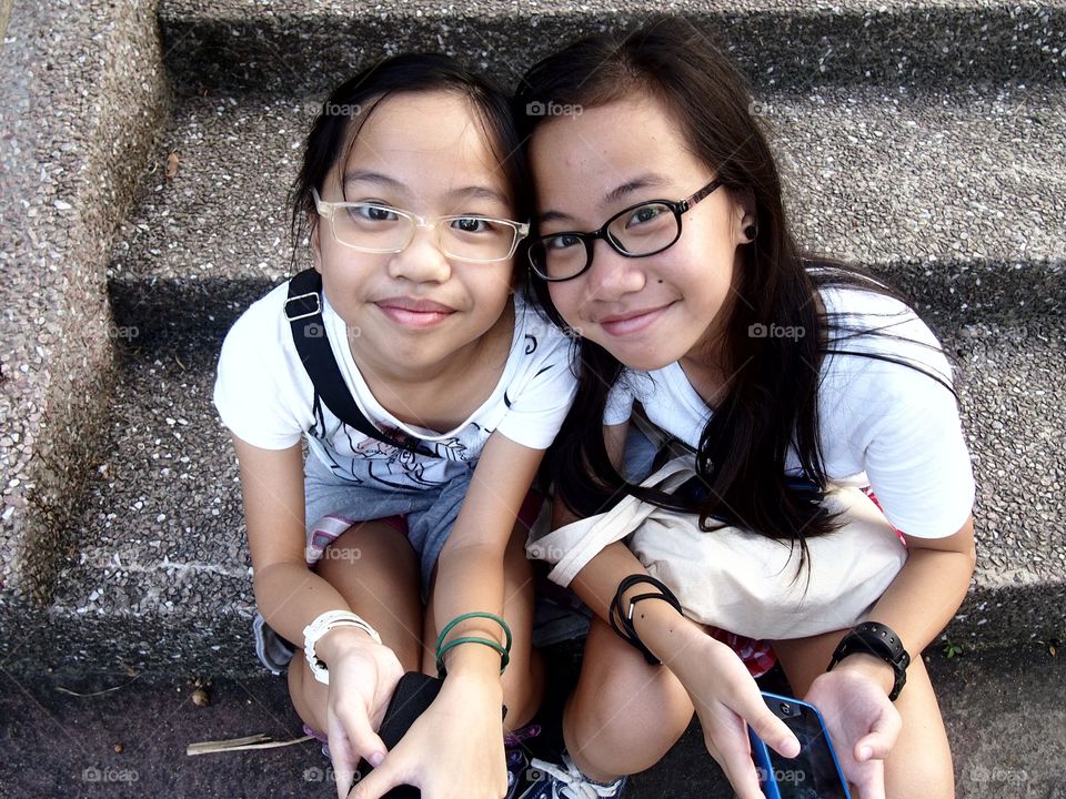 two young girls smiling at the camera