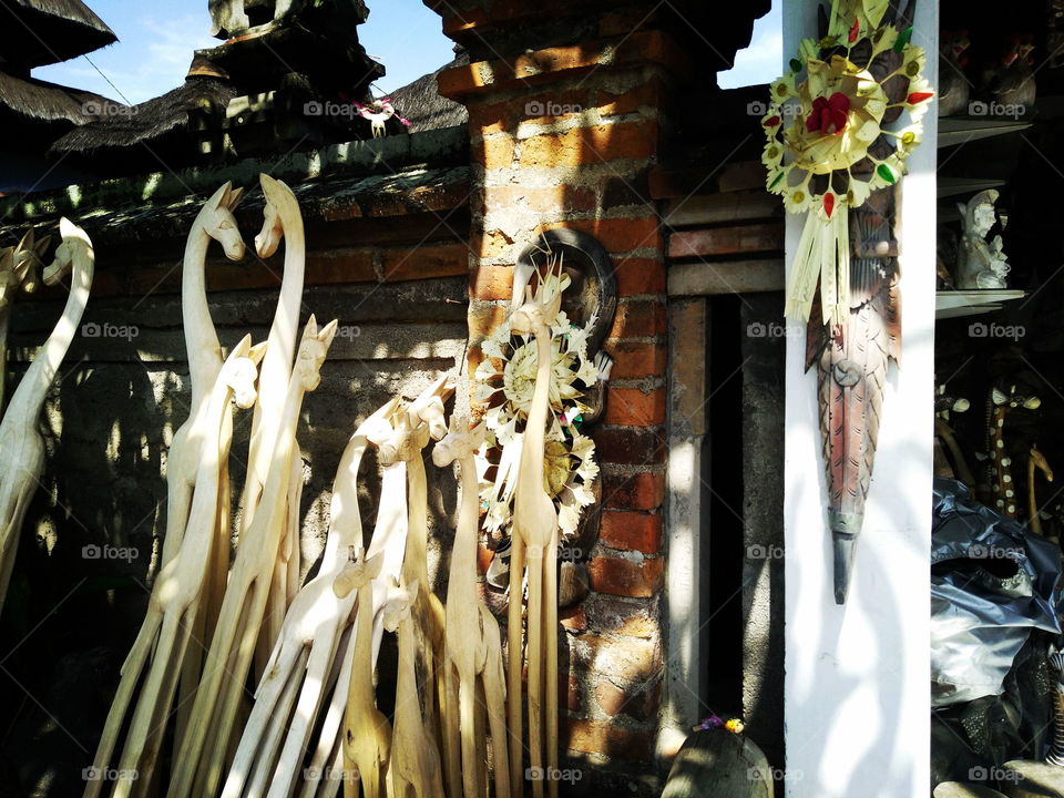 Wood carving in front of a temple in Ubud, Bali, Indonesia