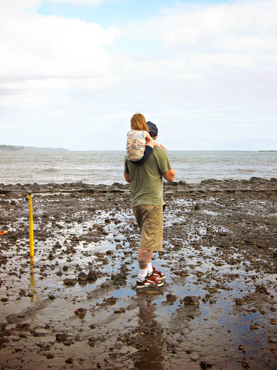 Father and daughter enjoying the Hawaiian beach view