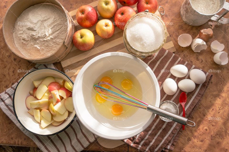 Making homemade puffed apple pie with eggs, sugar and flour.