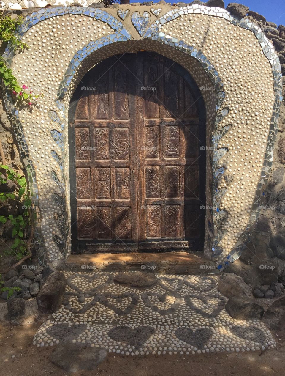 Wooden door with mosaic surround
