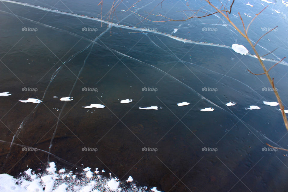 Snowy Footprints Across A Frozen Pond