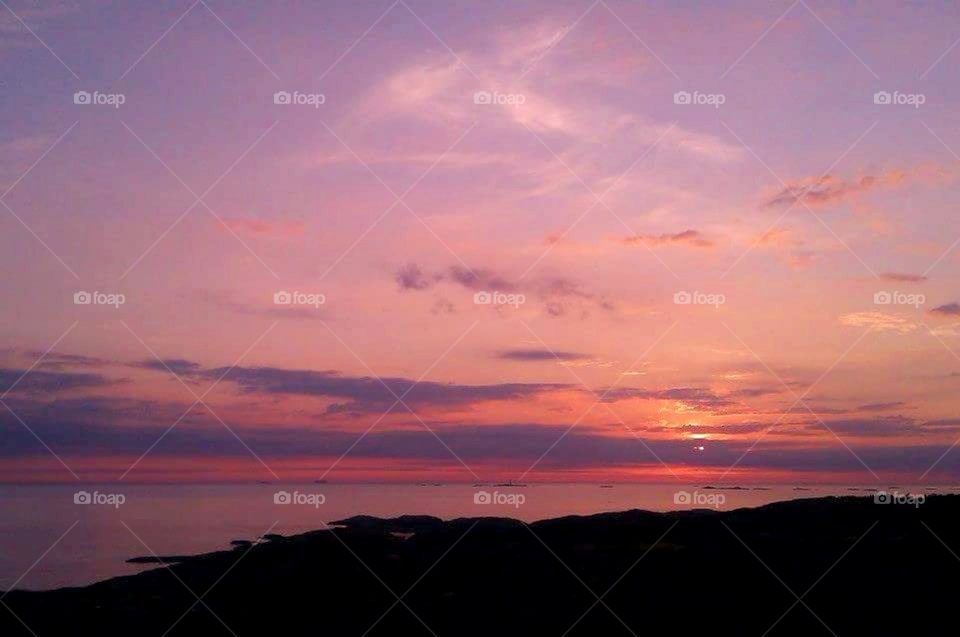 Purple, pink and orange sunset by the sea