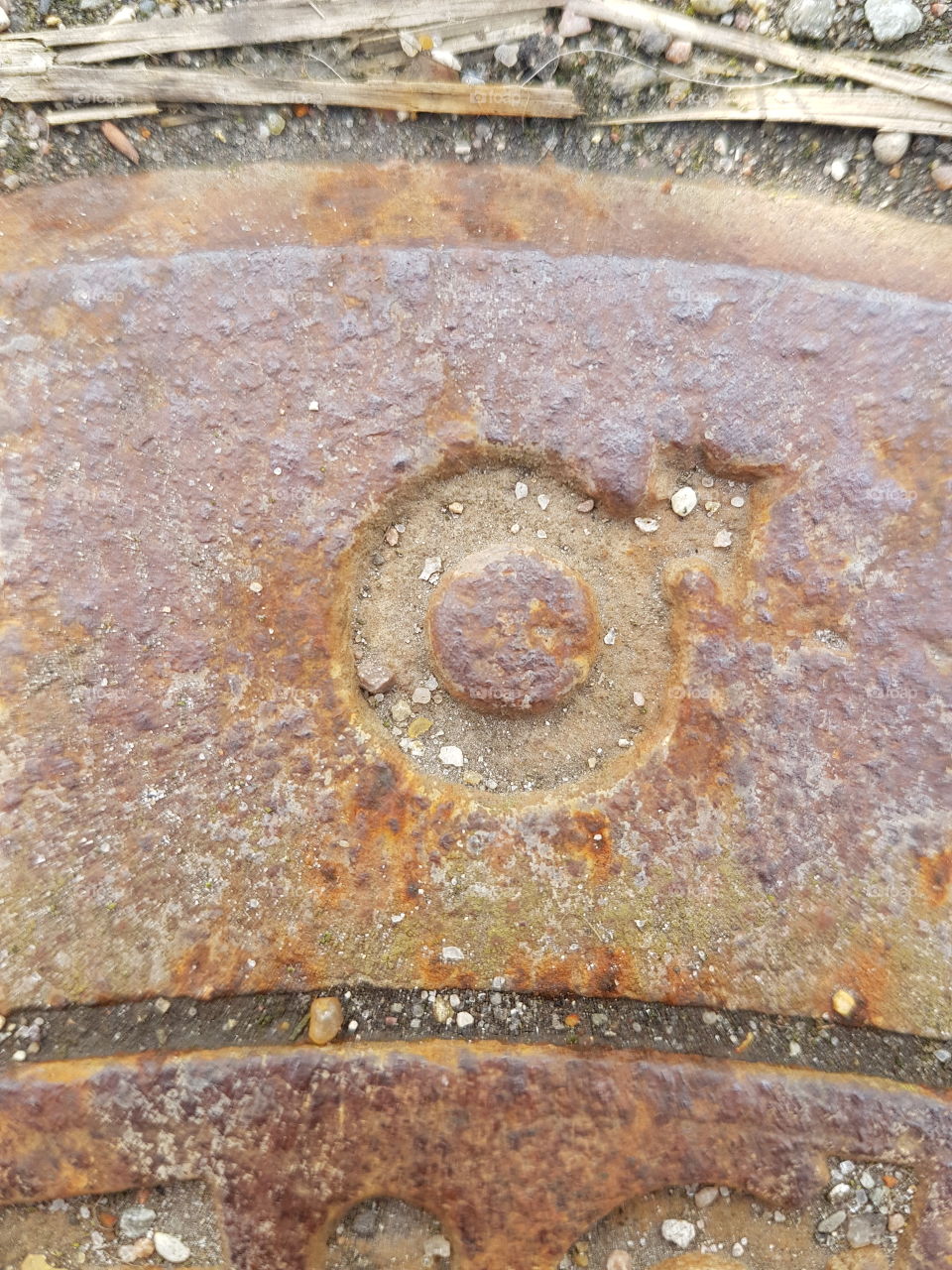 rusted symbol on manhole cover