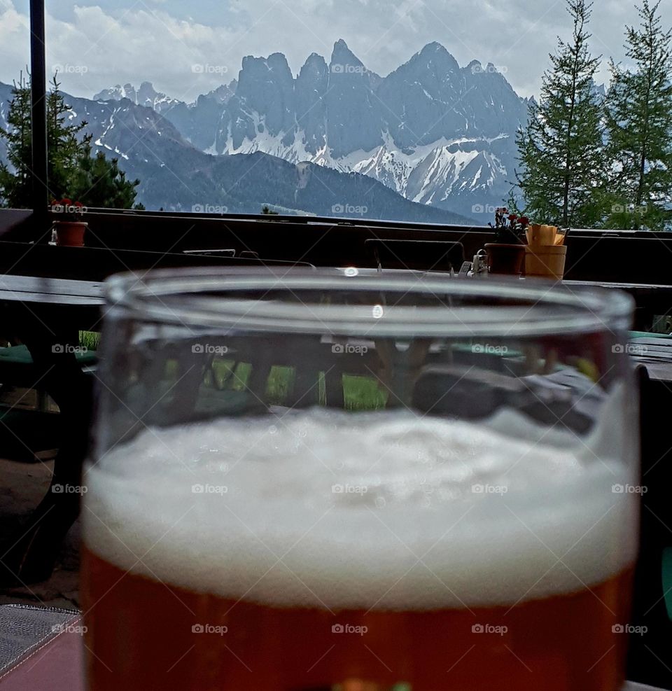 Drinking a white beer on a alpine hut in the Dolomites with a look to Latemar