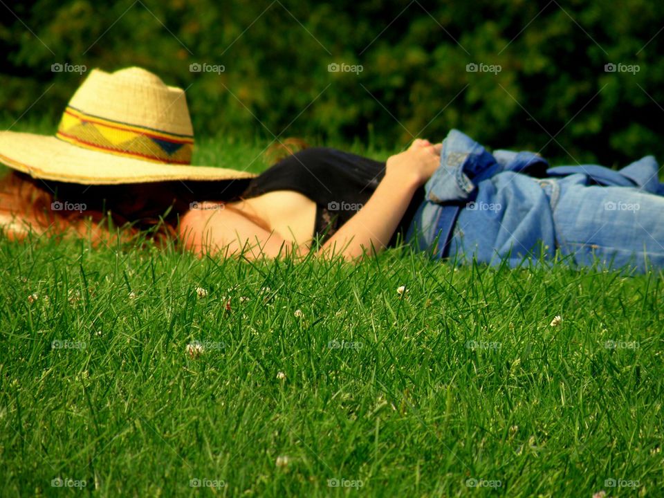 Siesta in the Grass. A park overlooking Camden Harbor, Maine a girl decided to take a nap.