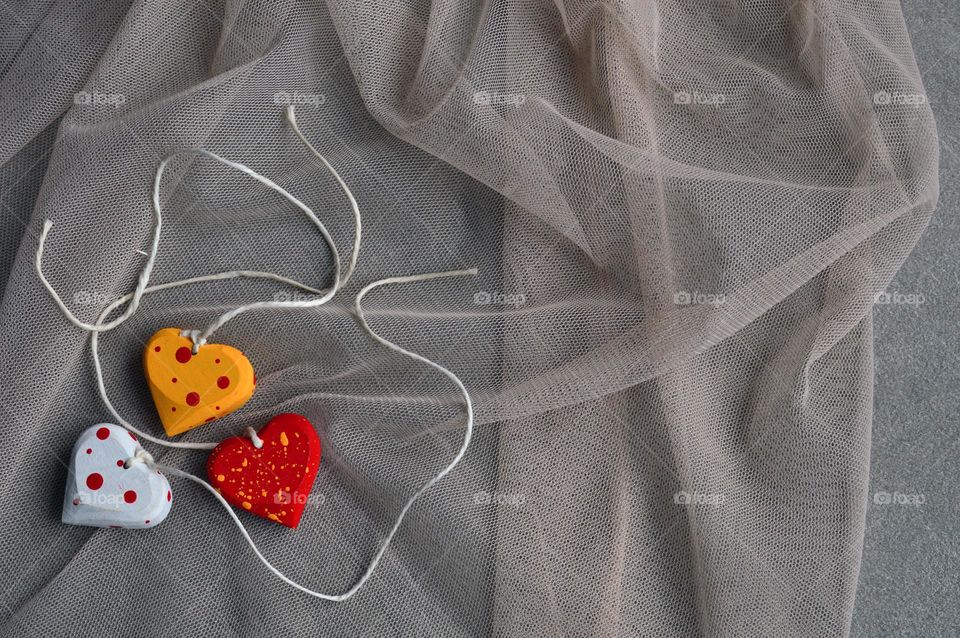 Multicolored wooden hearts on a thread