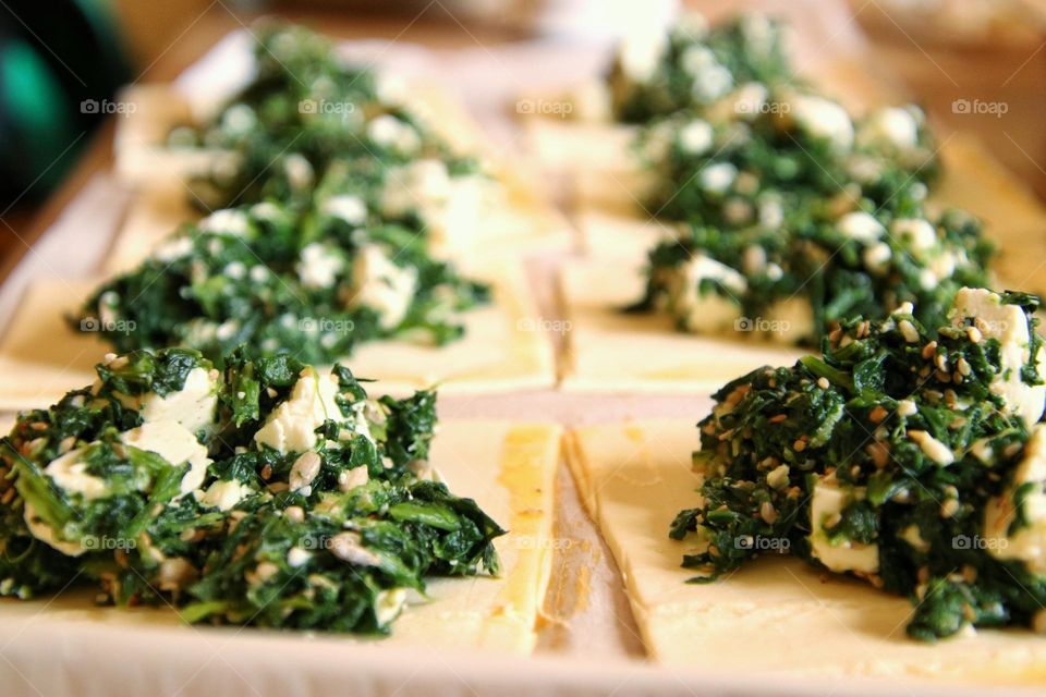 Close-up of a spinach and feta filling on puff pastry