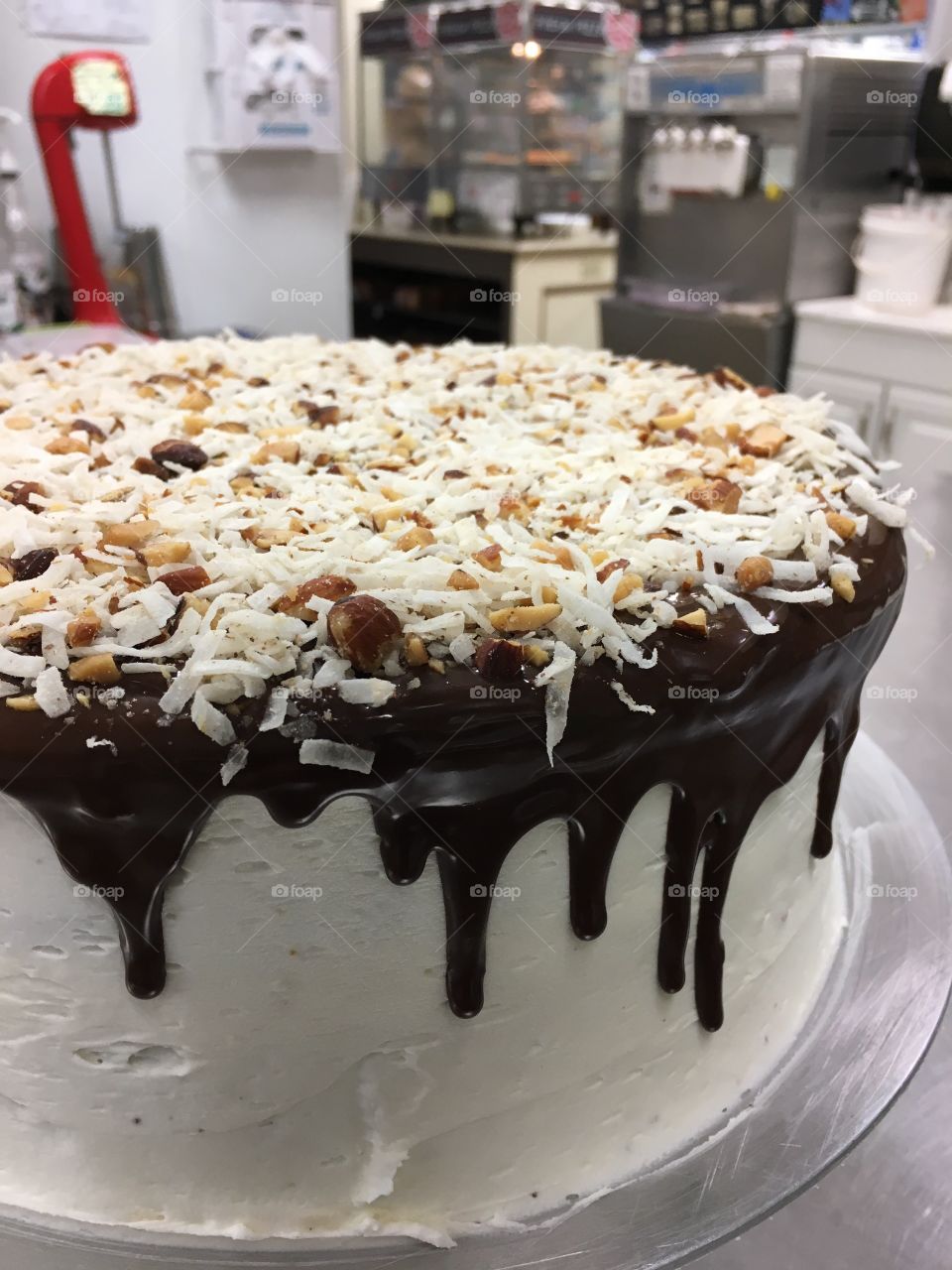 Another take on Almond Joy cake! Chocolate cake, coconut frosting, and chocolate drip topped with crushed almonds and shredded coconut. 