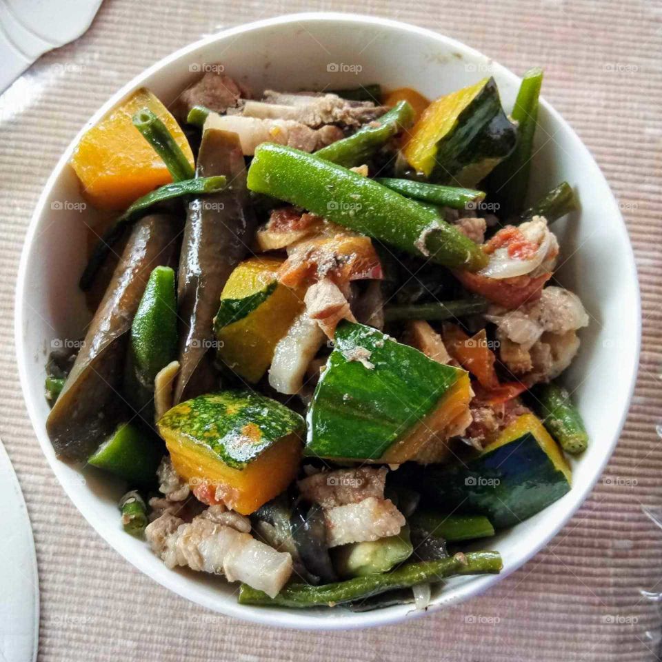 Pinakbet, a Filipino dish. Strips of pork, assorted vegetables, squash, string beans, okra, ampalaya and eggplant seasoned with fish sauce called Bagoong.