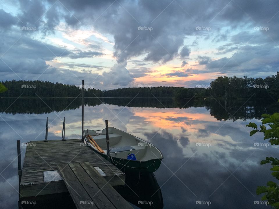 Boat moored by pier in lake