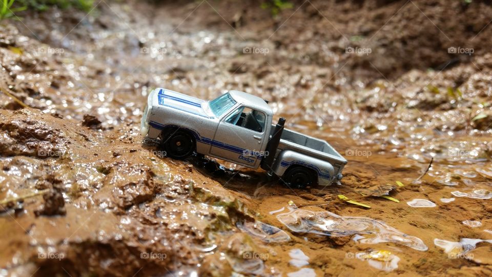 miniature photo of a car crossing a river