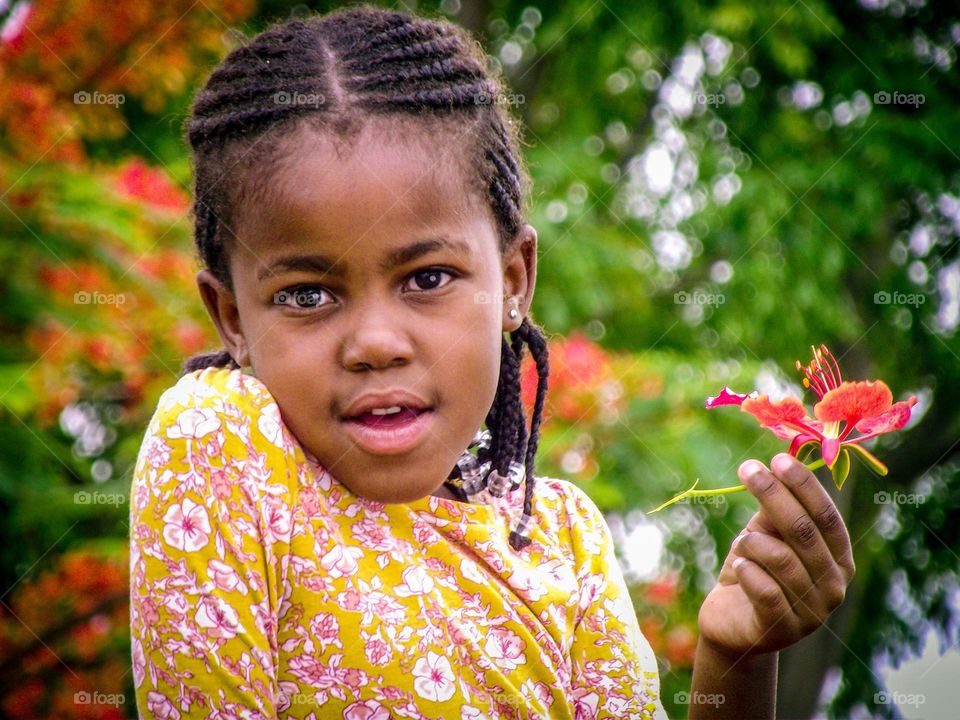 a kid holding a flower