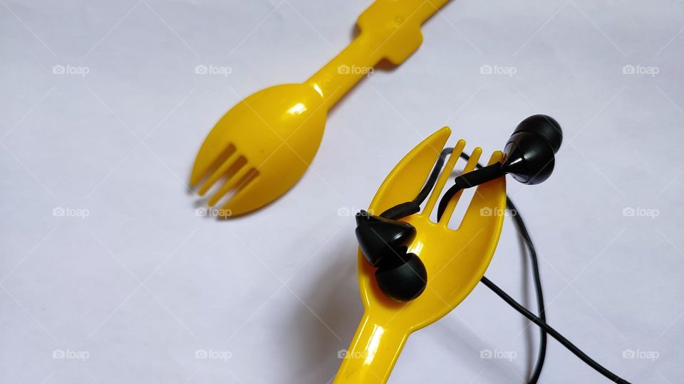 Yellow forks Trying to grab some music with earphones