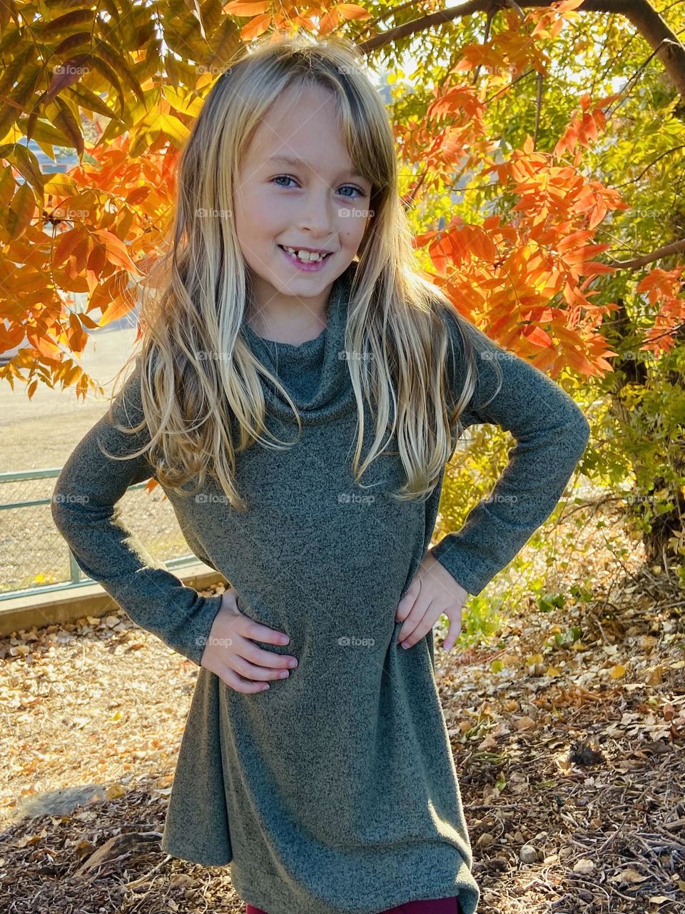 Beautiful little girl in bright fall leaves 