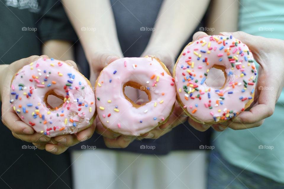 Hands showing donuts