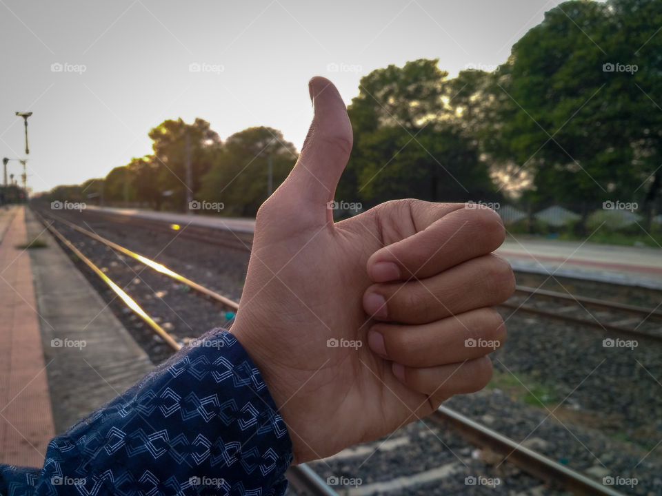 Thumbs Up ! for the beautiful evening sunset view on the Railway Station / evening sunlight, shinning behind the trees / Railway tracks / it's ok / locomotive / randomly clicked