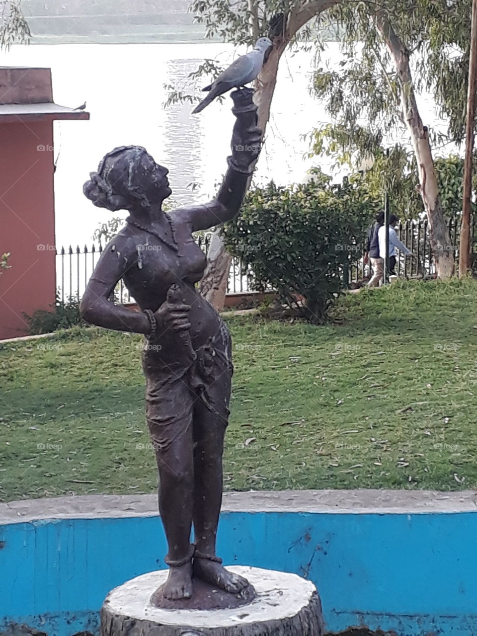 statue in garden with pigeon