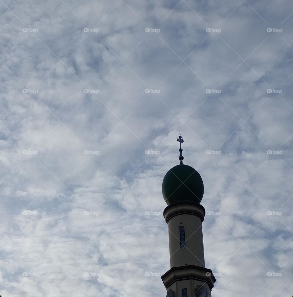 the mosque has a minaret, seen directly from below
