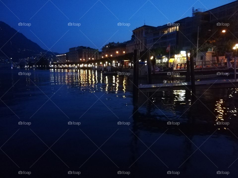 Night scape in Lugano, Switzerland. City lights reflecting in the lake.
