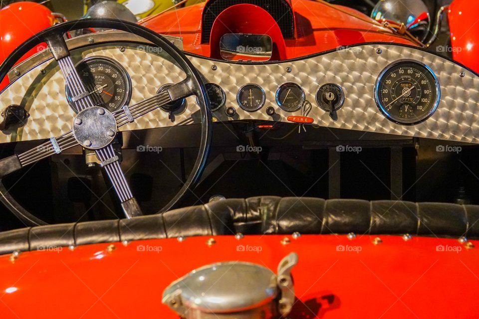 Turned aluminum and steel form a race car from the 1930's while the steering wheel is wood and chrome