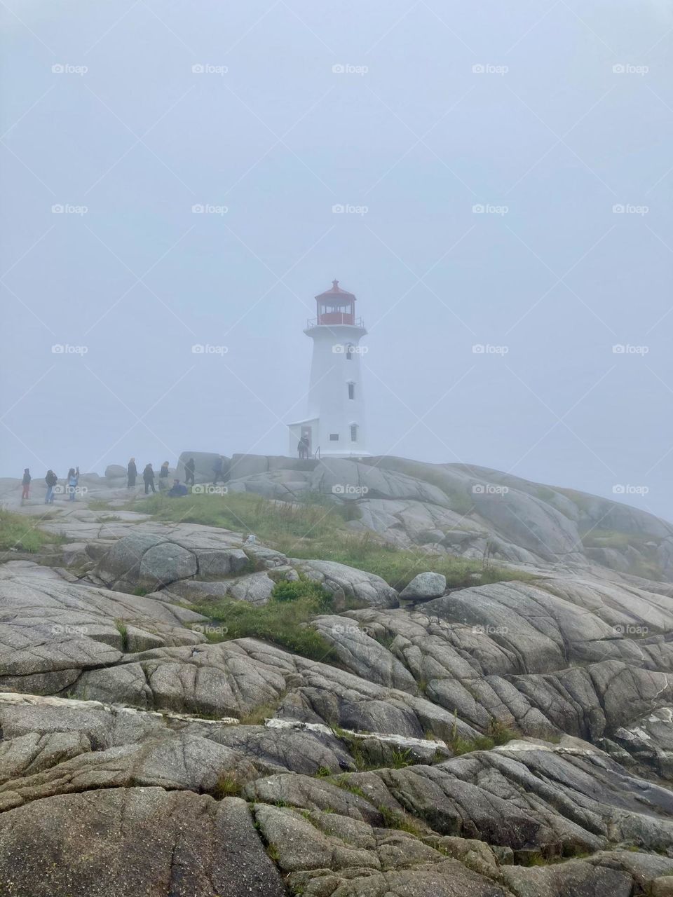 Iconic Peggy’s Cove lighthouse in a thick fog.