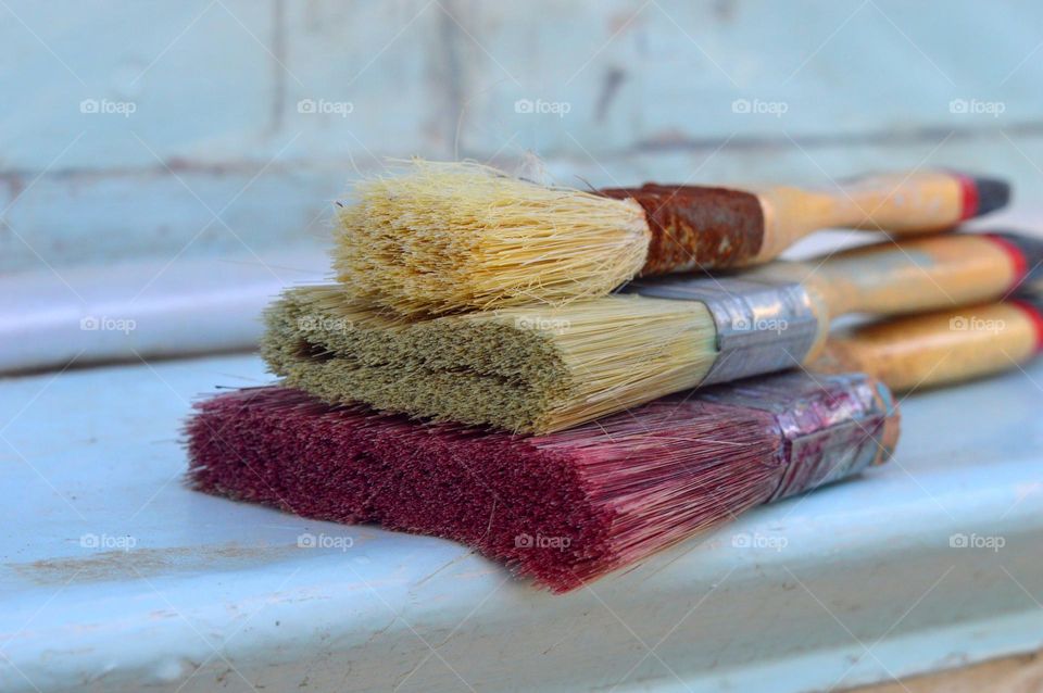 paint brushes pure colored lie against the wall beautiful background bright wallpaper