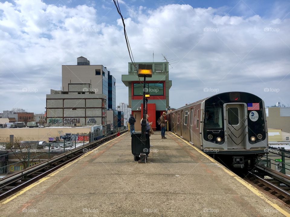 Platform and Passengers at the Train Station in Queens, New York City in 2017