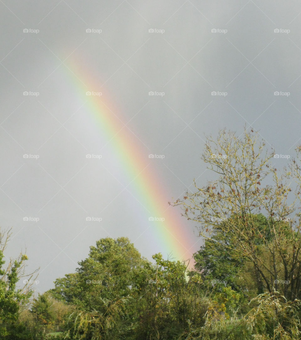 A rainbow brightens up a cloudy sky - #nofilters, #truephotos 