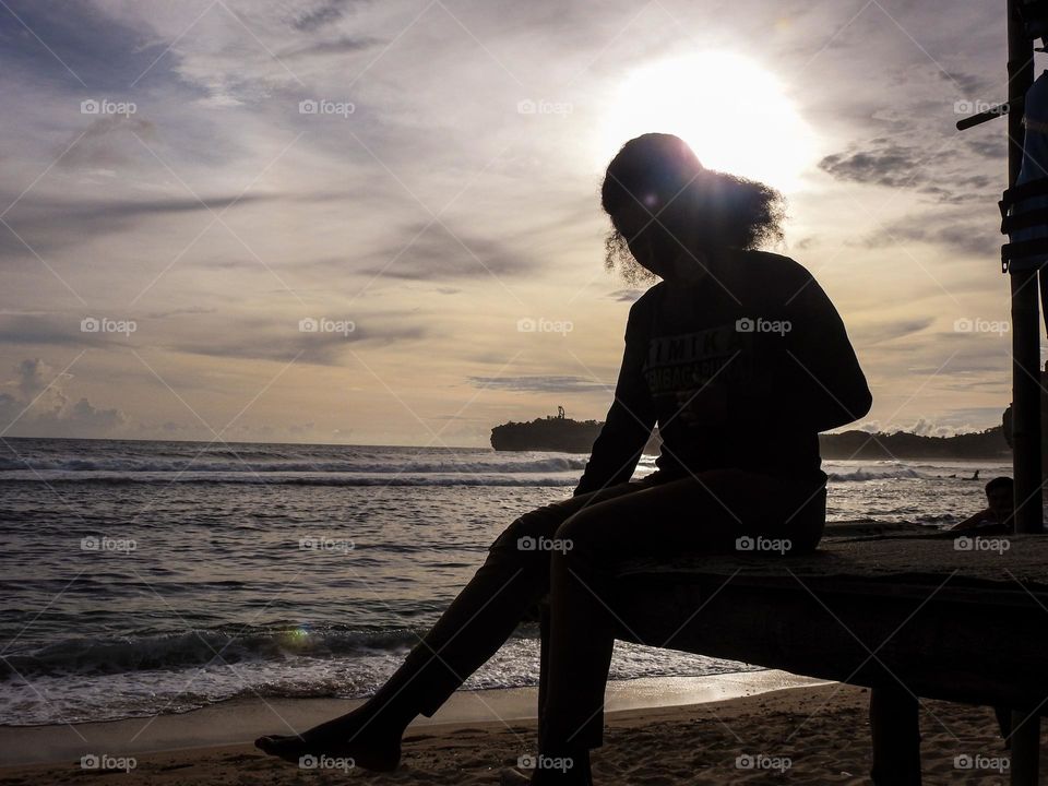 someone sitting on the beach.