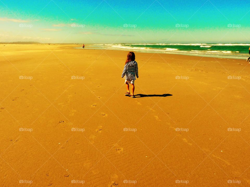 Little girl walking on Cannon Beach, Oregon