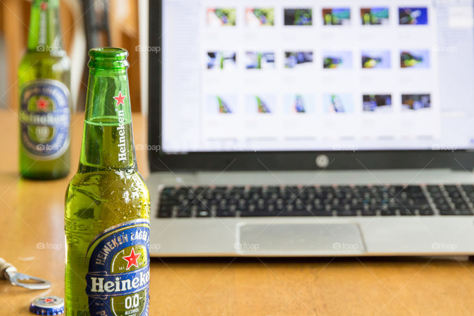 Having a cold Heineken by the laptop 