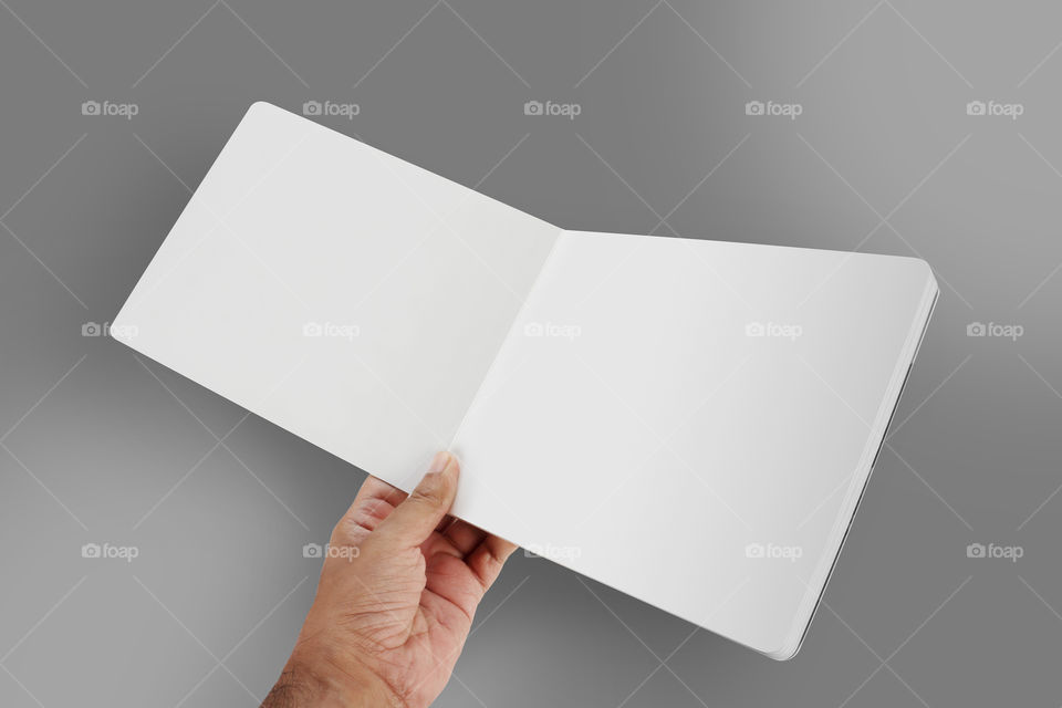 Blank white Open brochure in a hand