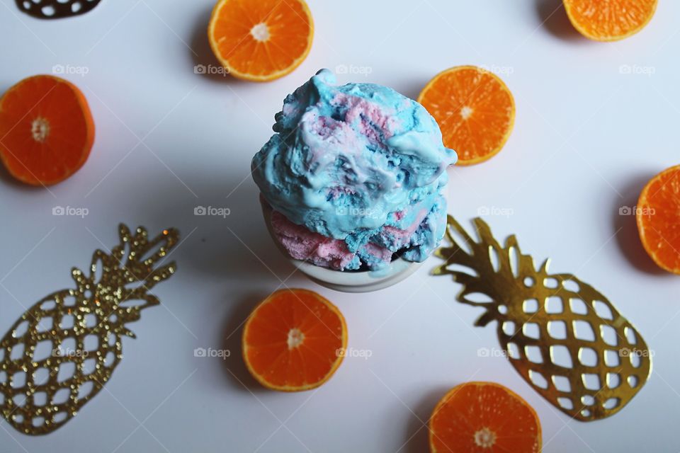 High angle view of ice cream and halved oranges