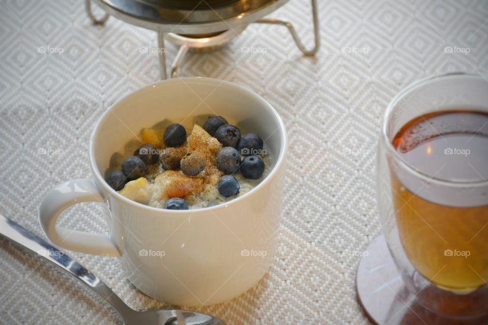 Healthy blueberry apple oatmeal with tea