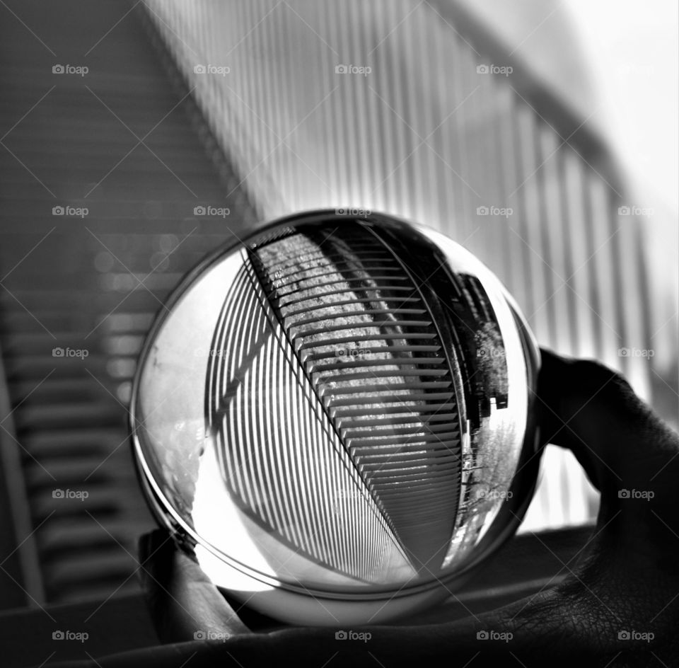 abstract crystal clear glass ball with striped black and white industrial pattern