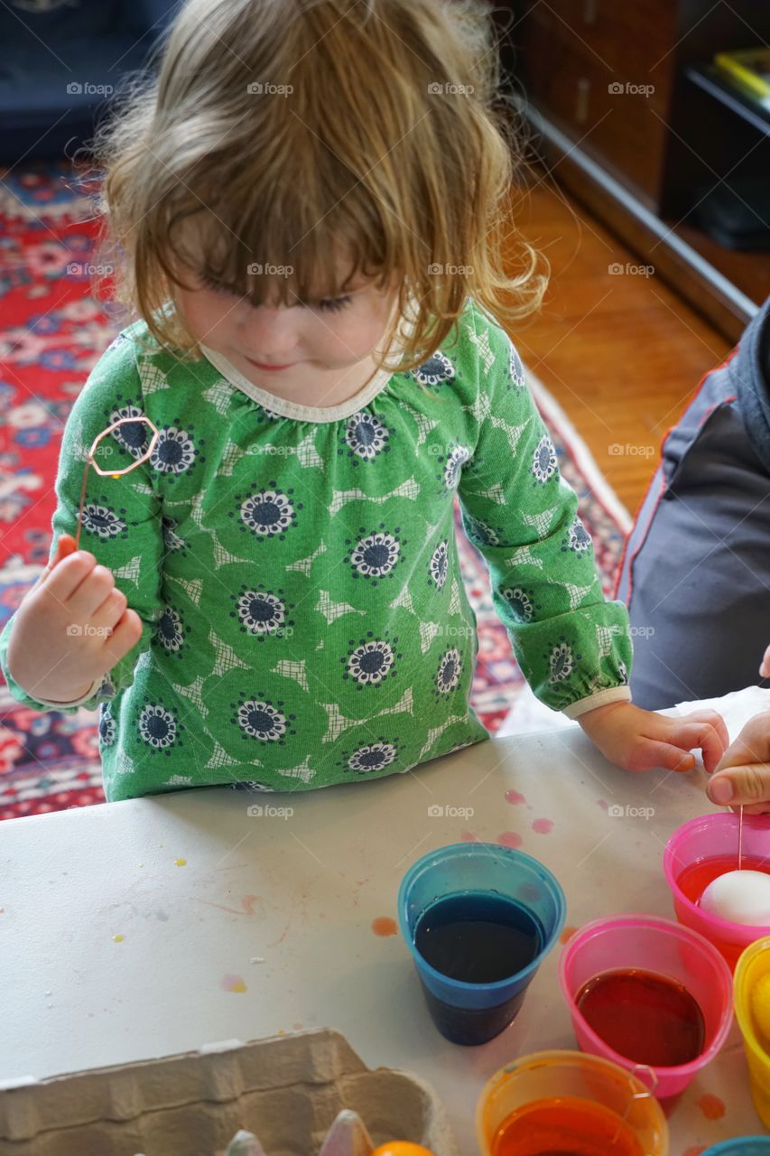 Little Girl Coloring Easter Eggs