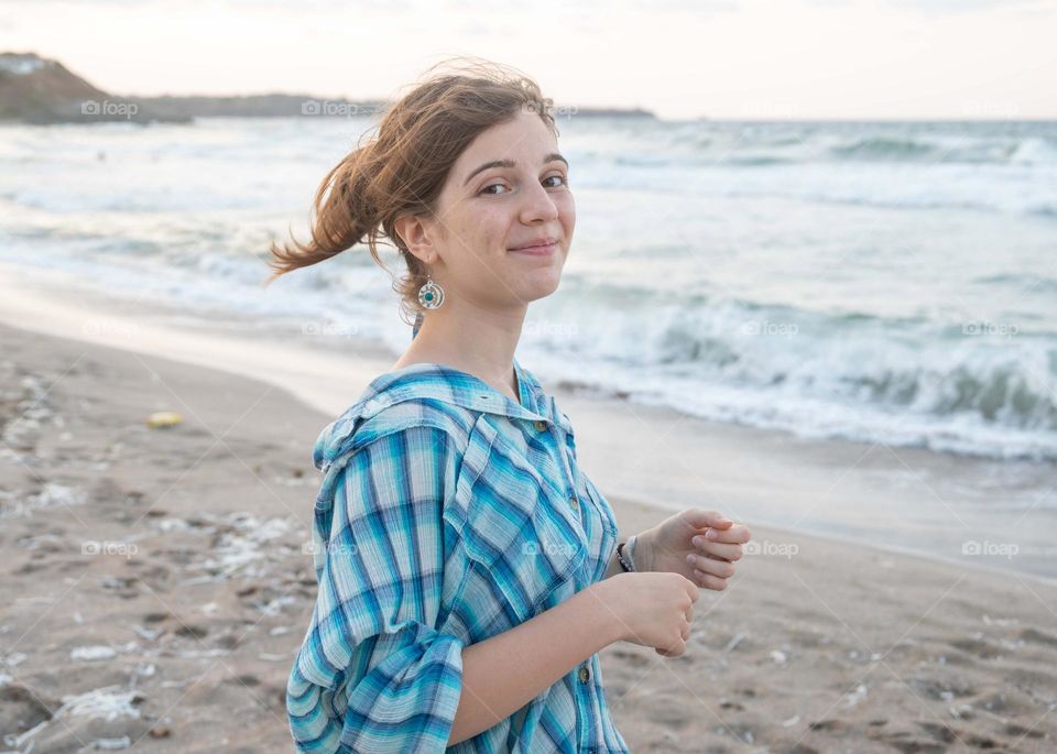 Energetic, Light-Hearted, and Vibrant Portrait of Blonde girl, on sea background
