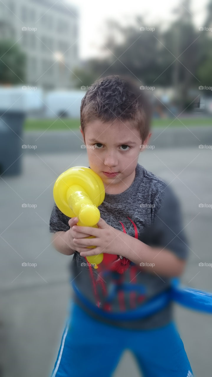 boy with balloon laser gun