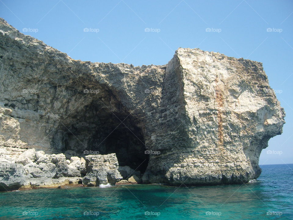 Malta seashore steep rocky slopes with caves