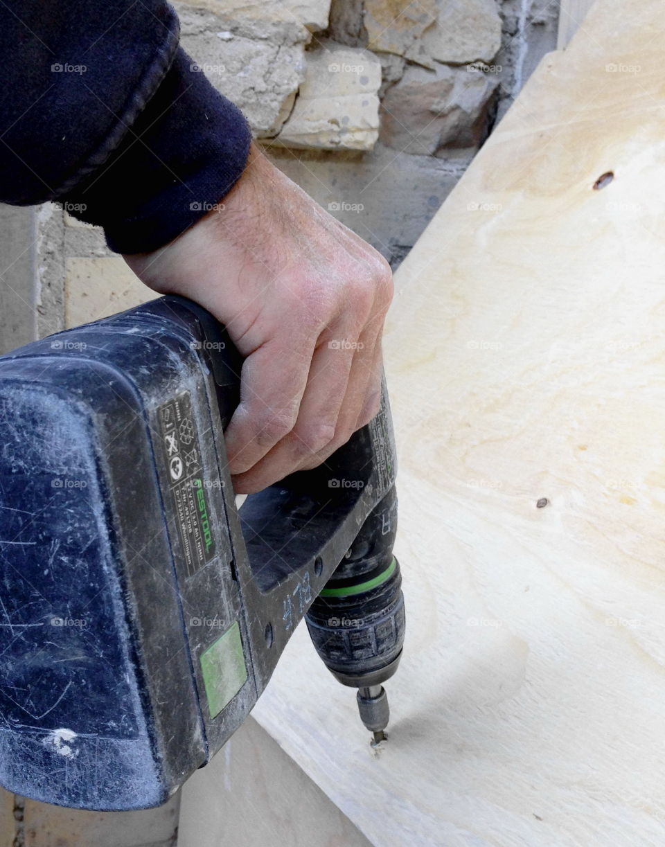 Craft worker with a drill.