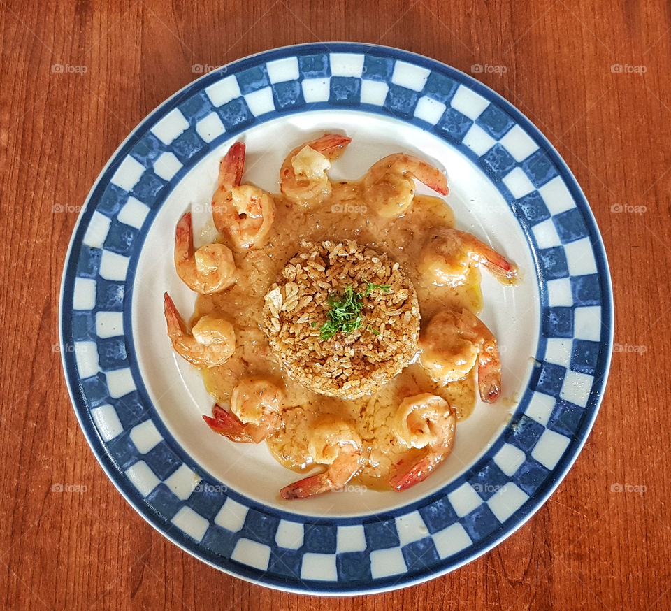 shrimp with coconut milk sauce and cajun rice